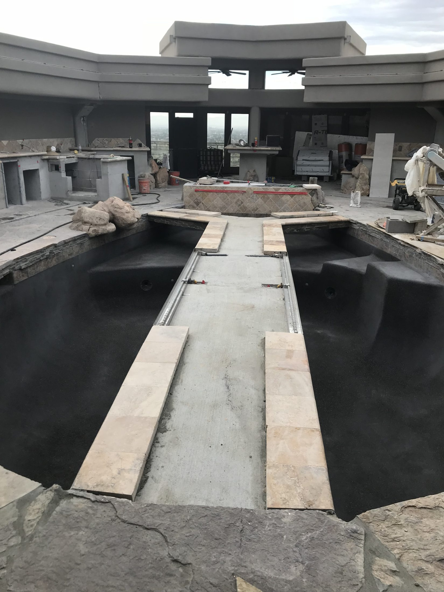 Dark pond finish applied with tile work underway along the edge
