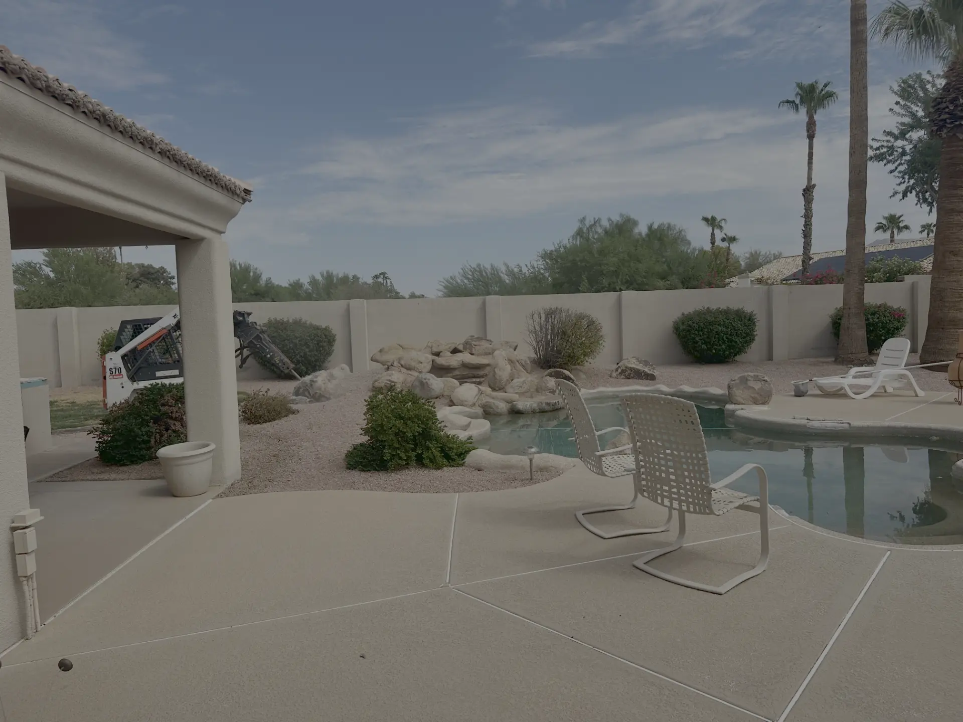 Original backyard pool and rock waterfall before renovation