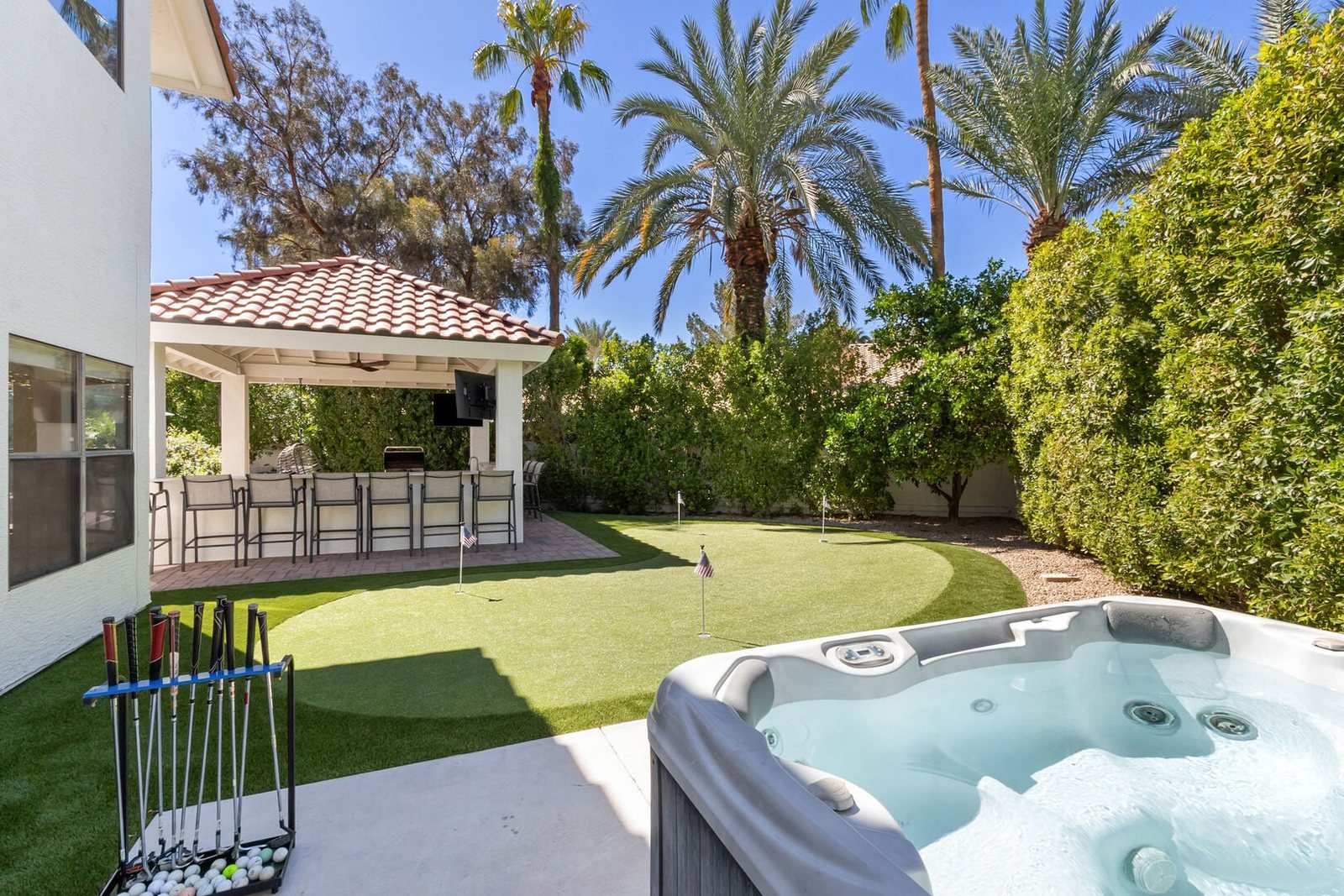 In-ground style hot tub spa framed by new hardscape and turf