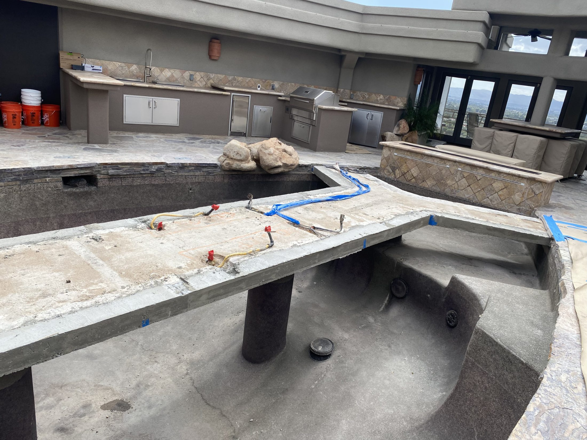 Finished outdoor kitchen with the pond walkway nearing completion
